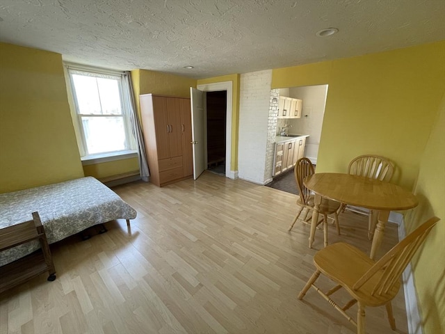 74 Newhall Unit 9, Lynn, MA 01902 - bedroom featuring a textured ceiling, light wood-style floors, and ensuite bathroom