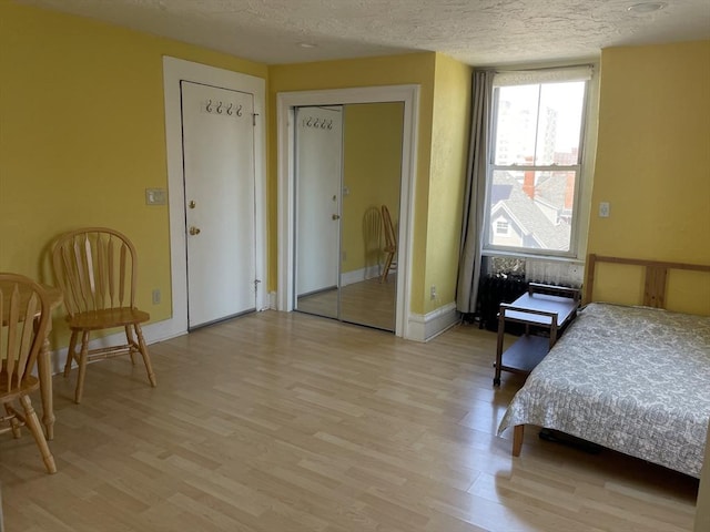74 Newhall Unit 9, Lynn, MA 01902 - bedroom featuring light wood-type flooring, a textured ceiling, and baseboards