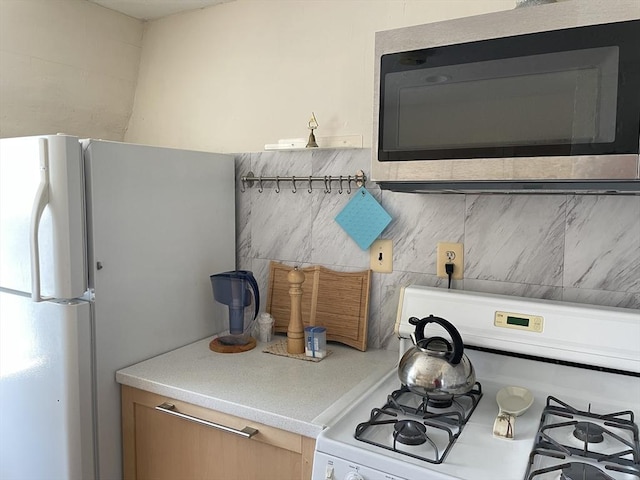 74 Newhall Unit 9, Lynn, MA 01902 - kitchen featuring white appliances, light countertops, and backsplash