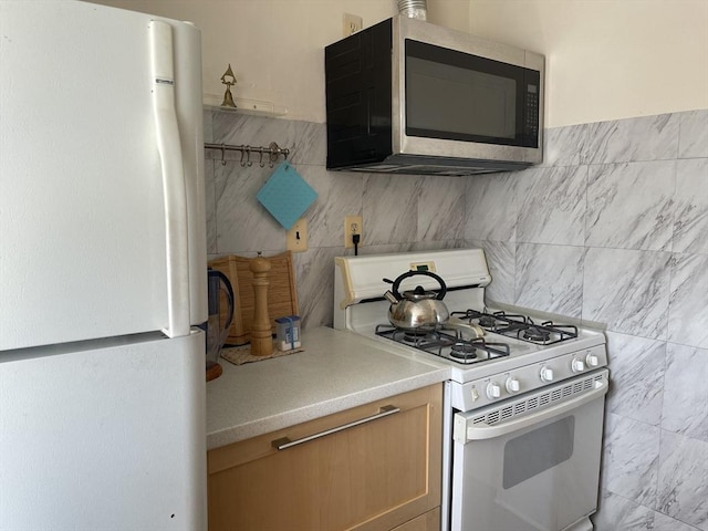 74 Newhall Unit 9, Lynn, MA 01902 - kitchen with white appliances, light countertops, tile walls, and tasteful backsplash