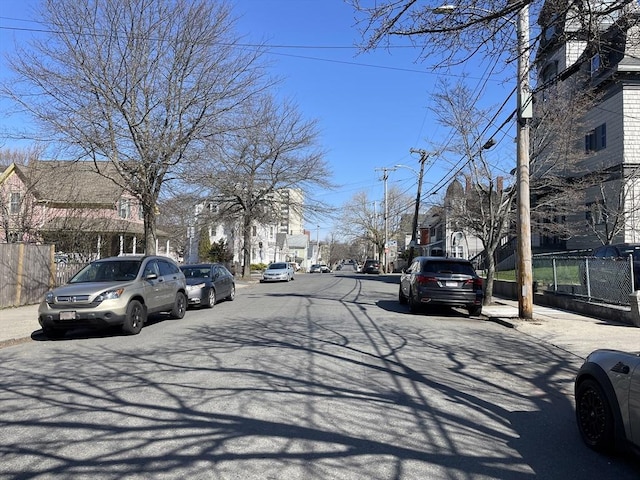 74 Newhall Unit 9, Lynn, MA 01902 - view of asphalt road featuring sidewalks, a residential view, curbs, and street lighting