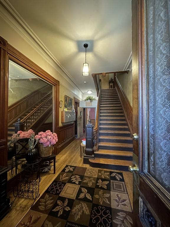 74 Newhall Unit 9, Lynn, MA 01902 - stairway featuring wood finished floors and ornamental molding