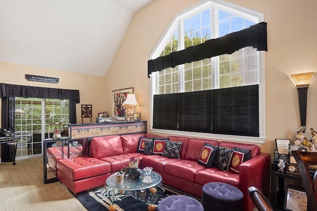 carpeted living room featuring high vaulted ceiling