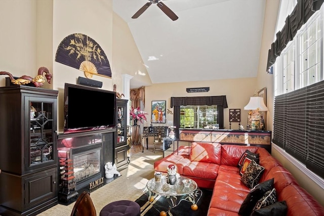 living room with light carpet, high vaulted ceiling, and ceiling fan