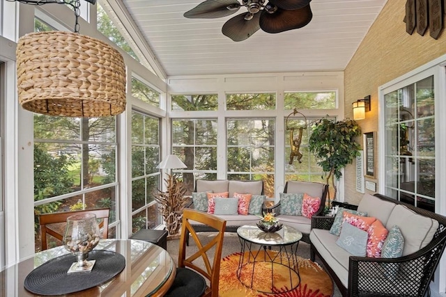 sunroom featuring plenty of natural light, ceiling fan, and vaulted ceiling