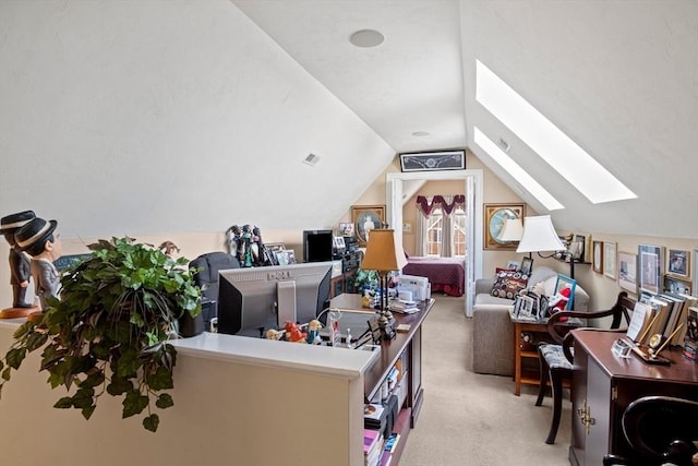 carpeted home office featuring vaulted ceiling with skylight