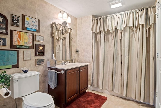 bathroom with tile patterned floors, a shower with curtain, vanity, and toilet