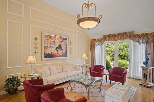 living room with high vaulted ceiling and light wood-type flooring