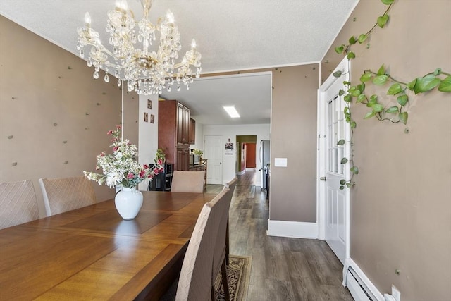 dining space featuring baseboard heating, a textured ceiling, a chandelier, baseboards, and dark wood-type flooring