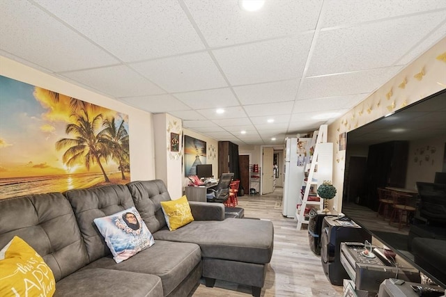 living area featuring recessed lighting, a paneled ceiling, and light wood finished floors