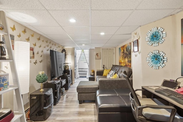 living area featuring recessed lighting, a drop ceiling, and wood finished floors