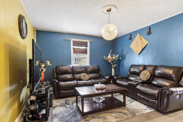 living area with a textured ceiling and wood finished floors