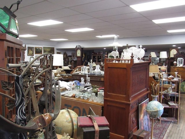 miscellaneous room featuring a paneled ceiling and wood finished floors