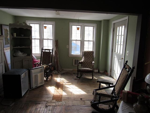 sitting room featuring visible vents, baseboards, and hardwood / wood-style floors