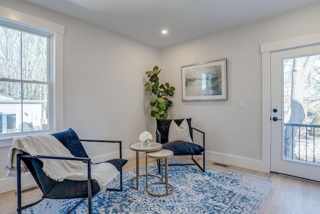 sitting room with light hardwood / wood-style flooring and a wealth of natural light