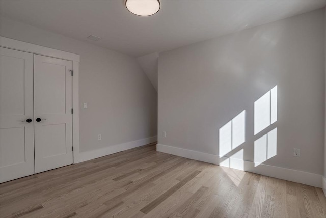 additional living space with light hardwood / wood-style floors