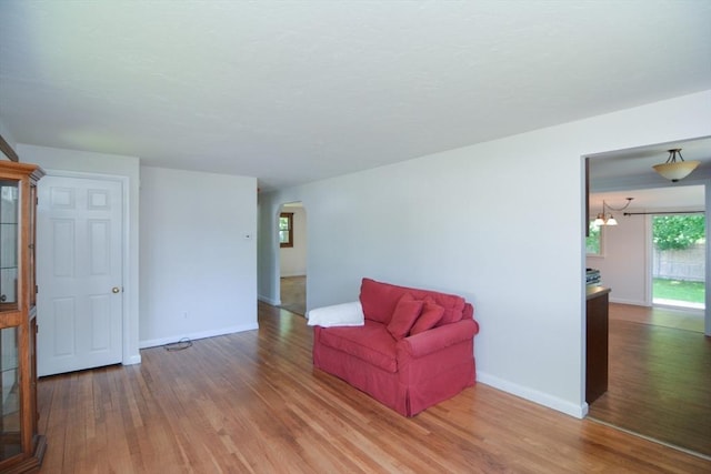248 Levin Rd, Rockland, MA 02370 - sitting room featuring wood finished floors, baseboards, a chandelier, and arched walkways