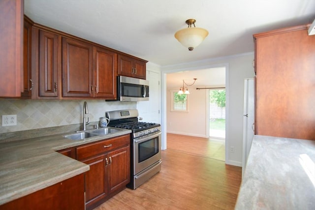 248 Levin Rd, Rockland, MA 02370 - kitchen with appliances with stainless steel finishes, a sink, tasteful backsplash, light wood-type flooring, and baseboards