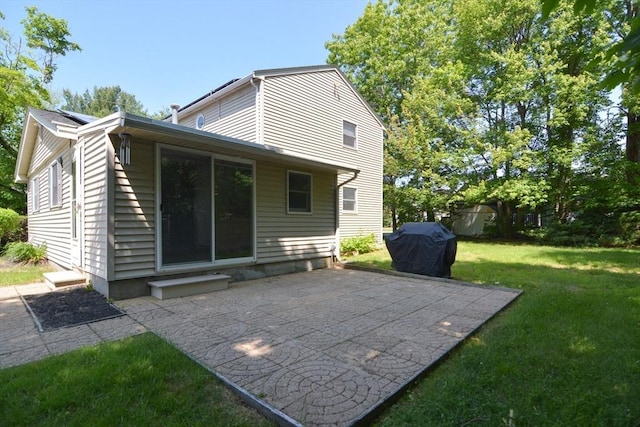 248 Levin Rd, Rockland, MA 02370 - back of property featuring a lawn and a patio area