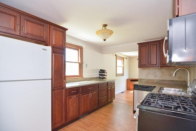 248 Levin Rd, Rockland, MA 02370 - kitchen with stainless steel appliances, a sink, healthy amount of natural light, light wood-style floors, and ornamental molding