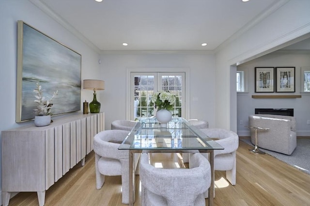 dining space with light wood finished floors, baseboards, crown molding, and recessed lighting