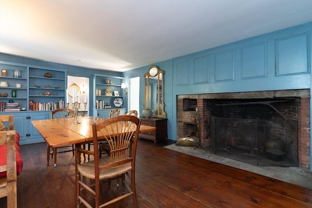 391 Brookfield Rd, Brimfield, MA 01010 - dining space with dark wood finished floors, a fireplace, and built in features