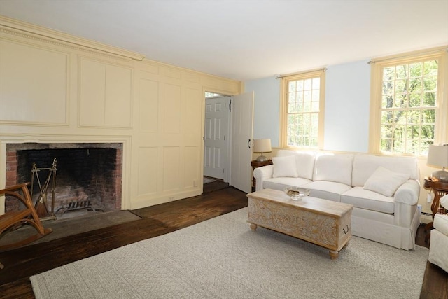 391 Brookfield Rd, Brimfield, MA 01010 - living area with hardwood / wood-style flooring, a brick fireplace, and a decorative wall