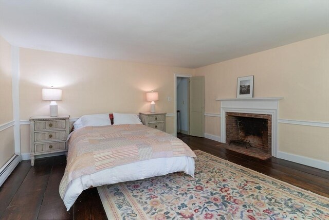 391 Brookfield Rd, Brimfield, MA 01010 - bedroom with hardwood / wood-style flooring, a fireplace, baseboard heating, and baseboards