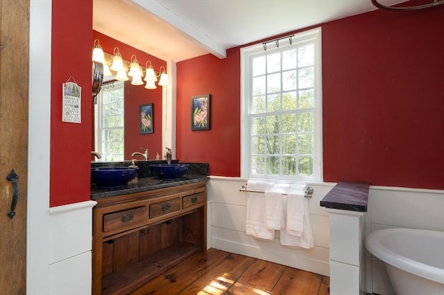 391 Brookfield Rd, Brimfield, MA 01010 - full bath featuring wainscoting, wood finished floors, healthy amount of natural light, beam ceiling, and a freestanding bath