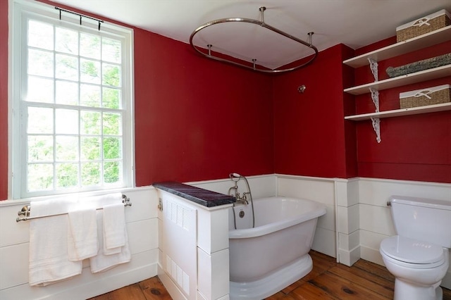 391 Brookfield Rd, Brimfield, MA 01010 - full bath with wood finished floors, toilet, wainscoting, and a soaking tub