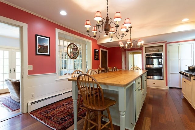 391 Brookfield Rd, Brimfield, MA 01010 - kitchen with wooden counters, baseboard heating, stainless steel appliances, a breakfast bar, and a chandelier