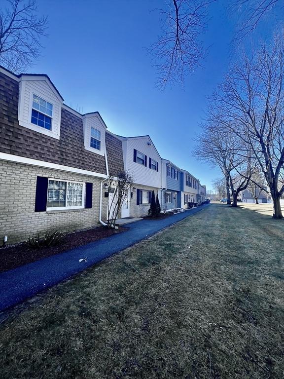 view of side of home featuring a lawn