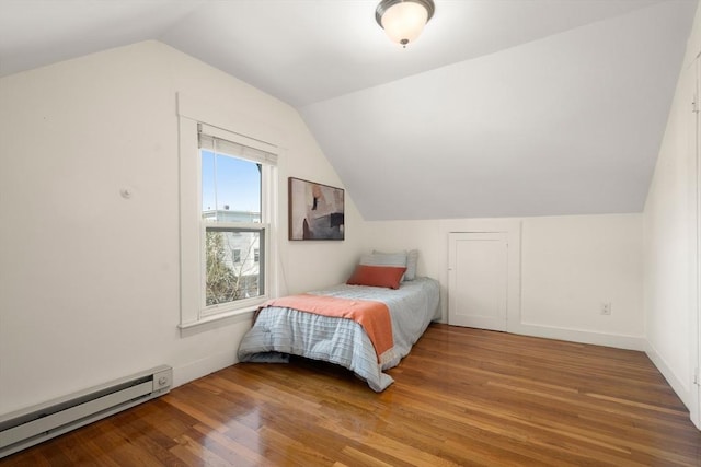 bedroom with baseboard heating, wood finished floors, and lofted ceiling