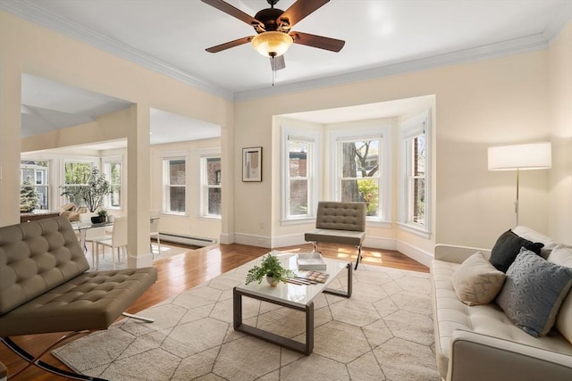 living room with plenty of natural light, light wood-style floors, baseboards, and baseboard heating
