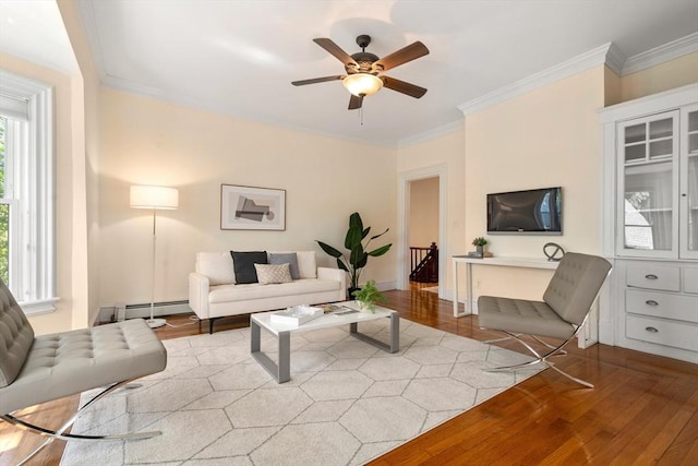 living room with crown molding, ceiling fan, a baseboard heating unit, and hardwood / wood-style floors