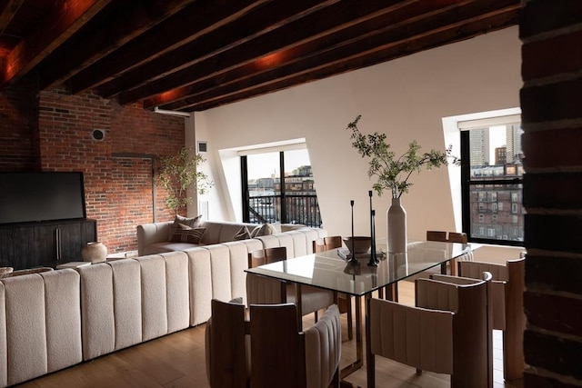 dining space featuring beamed ceiling and hardwood / wood-style flooring