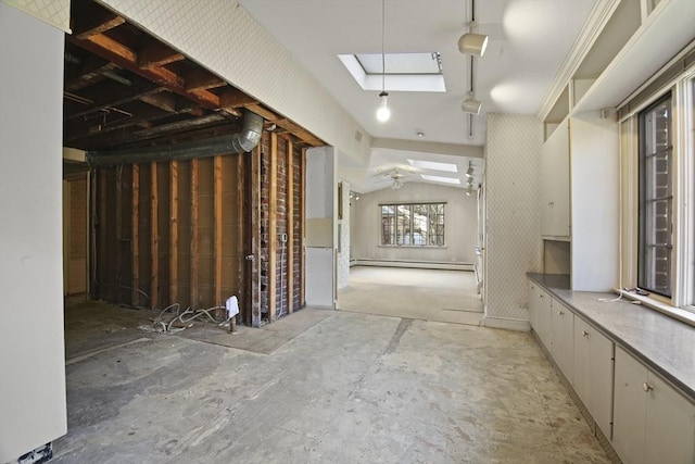 interior space featuring wallpapered walls, lofted ceiling with skylight, and baseboard heating