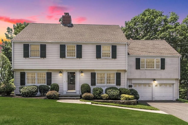 70 Orchard Ln, Melrose, MA 02176 - view of front facade featuring a chimney, driveway, a front lawn, a garage, and a shingled roof