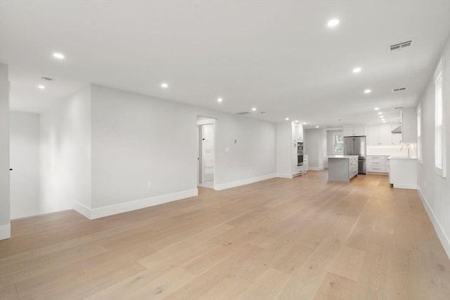 137-139 Crafts St, Newton, MA 02460 - unfurnished living room with recessed lighting, light wood-type flooring, and baseboards