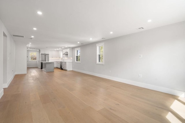 137-139 Crafts St, Newton, MA 02460 - unfurnished living room featuring recessed lighting, light wood-style flooring, and baseboards