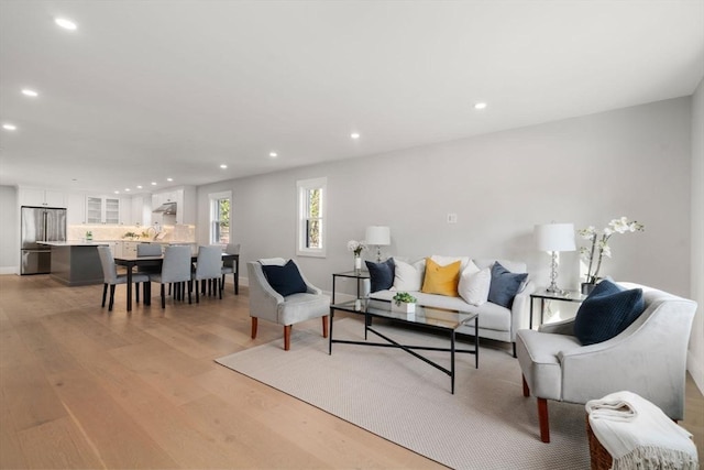 137-139 Crafts St, Newton, MA 02460 - living room with light wood finished floors, recessed lighting, and baseboards