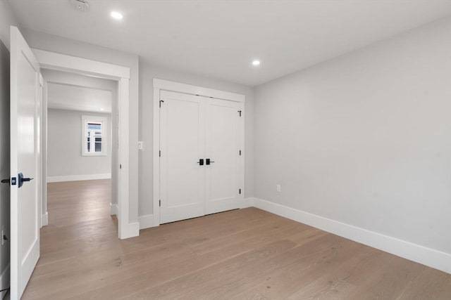 137-139 Crafts St, Newton, MA 02460 - unfurnished bedroom featuring light wood-type flooring, baseboards, recessed lighting, and a closet
