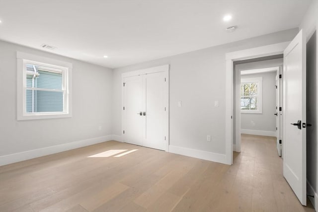 137-139 Crafts St, Newton, MA 02460 - unfurnished bedroom featuring light wood finished floors, baseboards, recessed lighting, and a closet