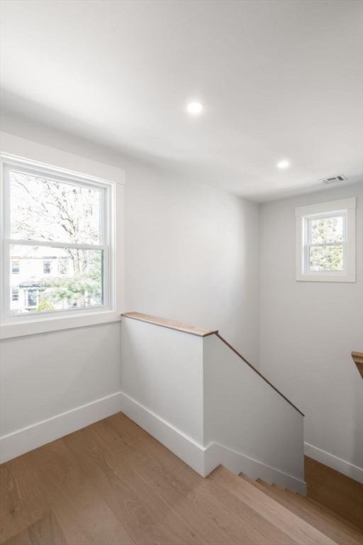 137-139 Crafts St, Newton, MA 02460 - empty room featuring light wood-style floors, baseboards, and recessed lighting