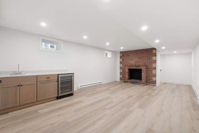 137-139 Crafts St, Newton, MA 02460 - unfurnished living room with beverage cooler, a baseboard heating unit, a sink, a fireplace, and light wood finished floors