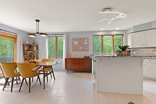 887 High Rock Rd, Fitchburg, MA 01420 - kitchen featuring plenty of natural light, white cabinets, tasteful backsplash, light stone countertops, and recessed lighting