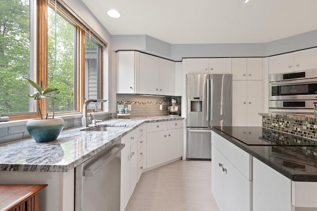 887 High Rock Rd, Fitchburg, MA 01420 - kitchen with stainless steel appliances, a sink, decorative backsplash, healthy amount of natural light, and recessed lighting