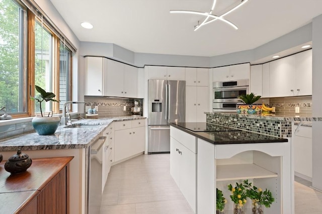 887 High Rock Rd, Fitchburg, MA 01420 - kitchen featuring appliances with stainless steel finishes, a sink, decorative backsplash, dark stone countertops, and white cabinetry