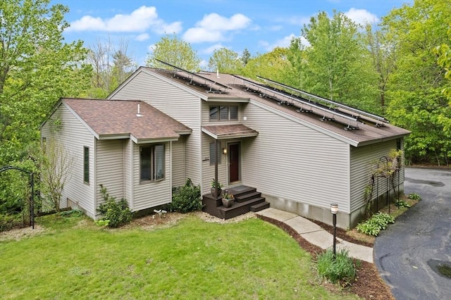 887 High Rock Rd, Fitchburg, MA 01420 - view of front of home featuring a shingled roof, a front lawn, and roof mounted solar panels