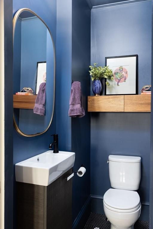26 Moultrie St Unit 26, Boston, MA 02124 - bathroom with toilet, tile patterned floors, a sink, and baseboards